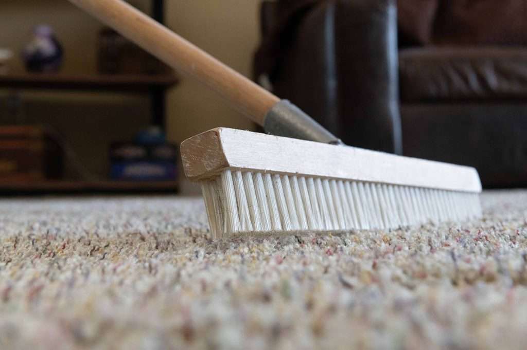 Close up of carpet rake on beige carpet
